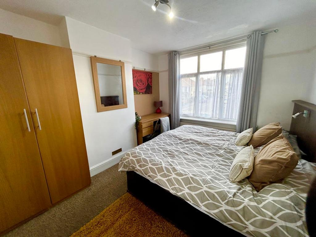 A bright and inviting double bedroom with ample...