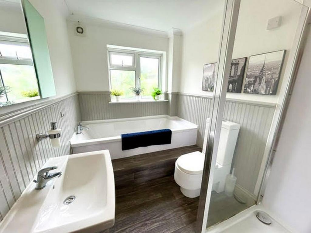 A spacious and well lit large bathroom featurin...