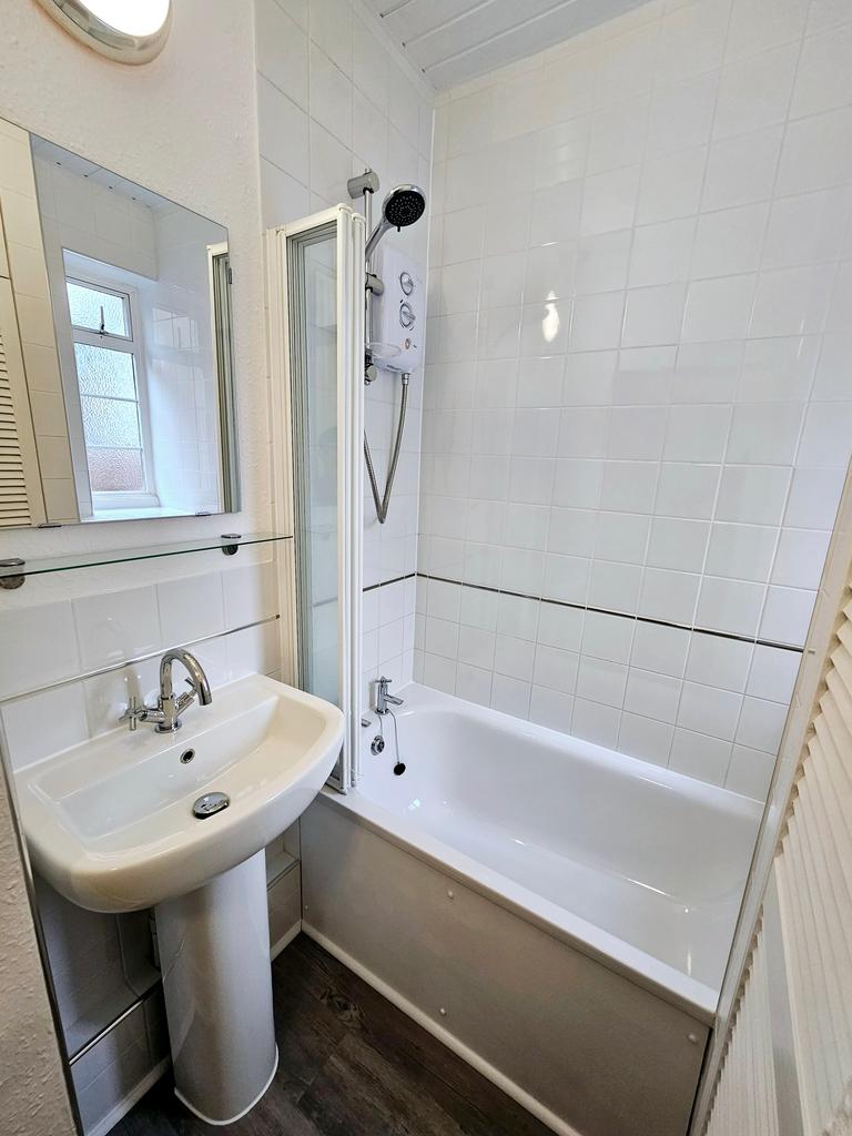 A bright and clean large bathroom featuring a b...