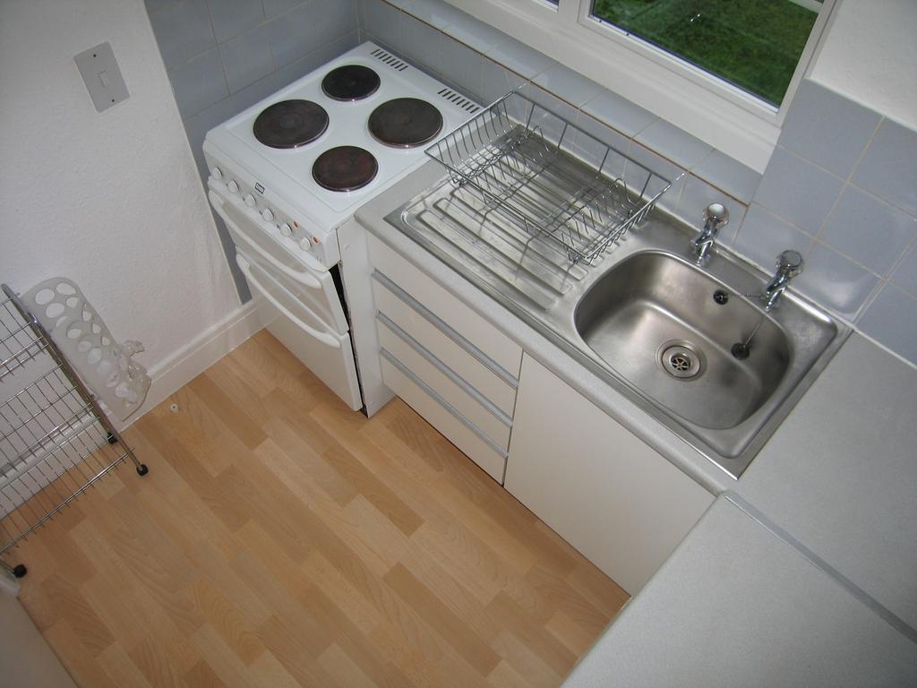 A tidy kitchenette with essential appliances, p...