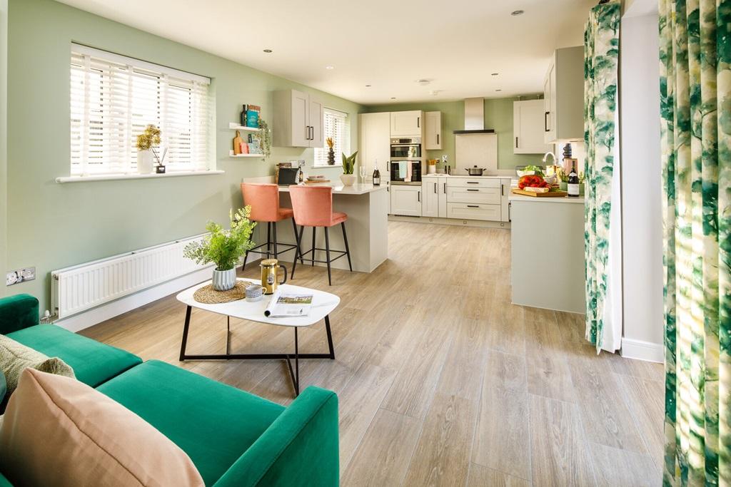 A large kitchen diner with French doors to the...