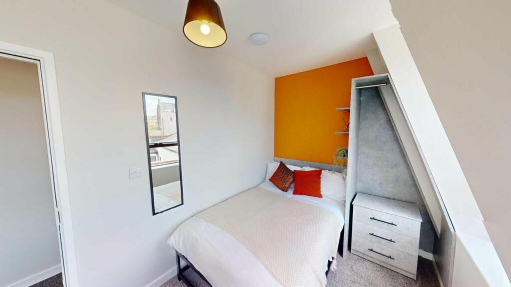 A bright and inviting double bedroom featuring ...