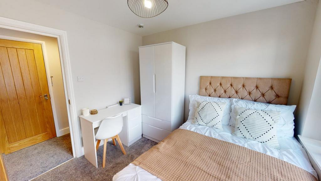 A bright and inviting double bedroom with moder...