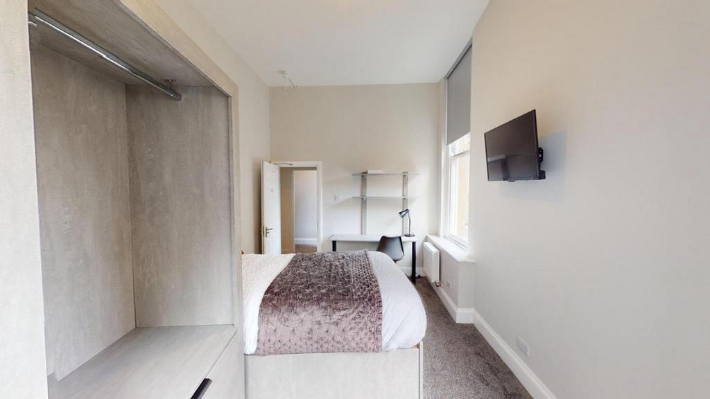 A bright and inviting double bedroom with moder...