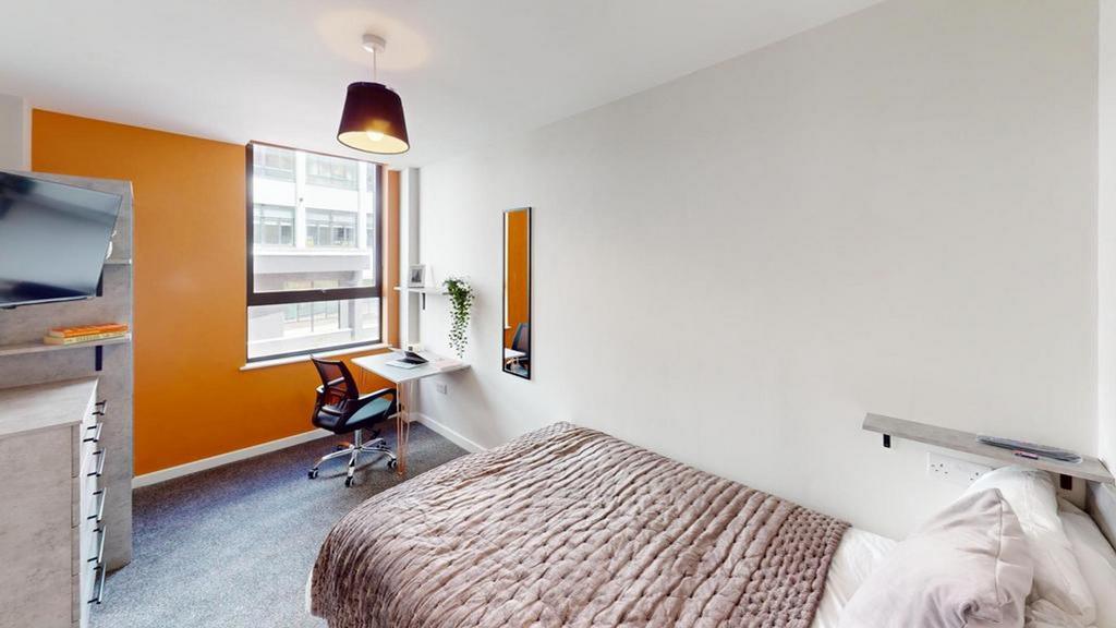 A bright and inviting double bedroom with a mod...