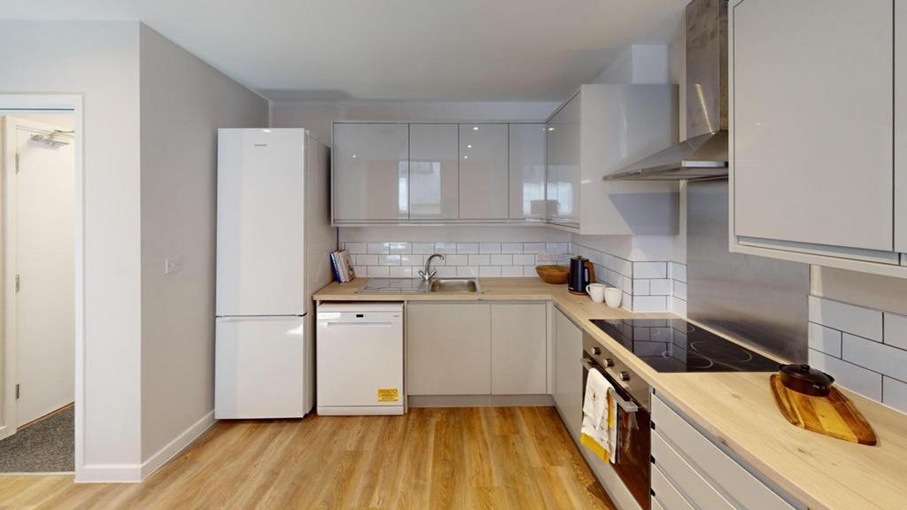 A modern and tidy kitchenette featuring sleek c...