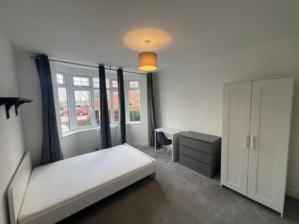 A bright and spacious double bedroom with ample...