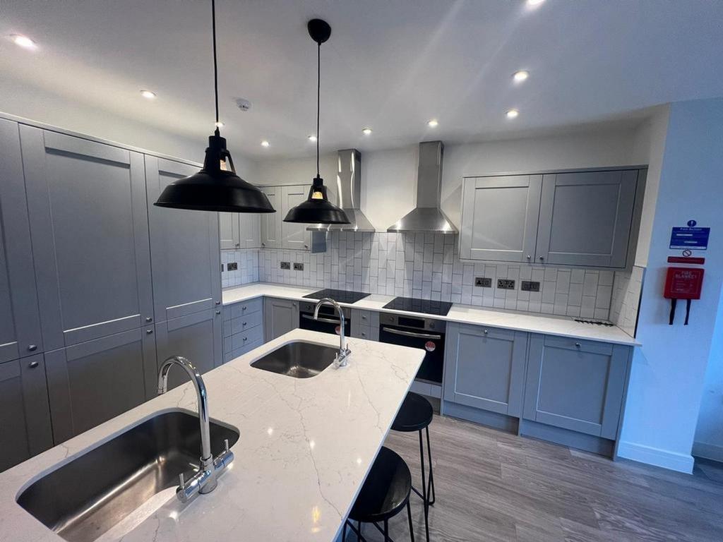 A modern and spacious kitchen featuring sleek c...