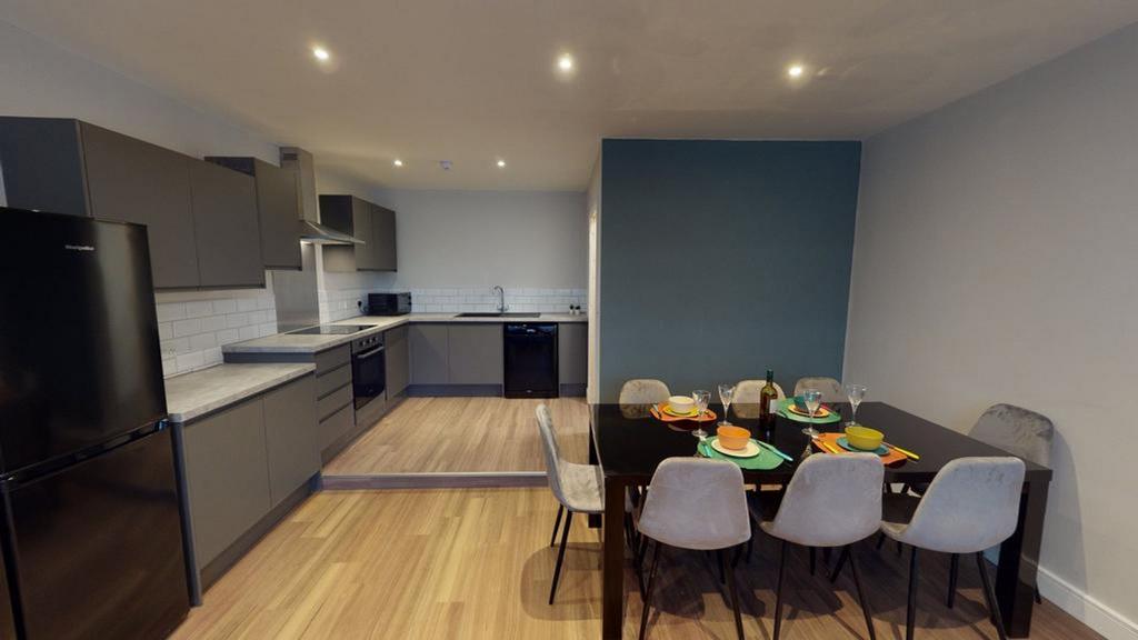 A modern and spacious kitchen with a dining are...