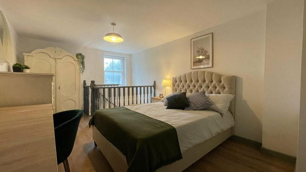 A bright and spacious double bedroom featuring ...