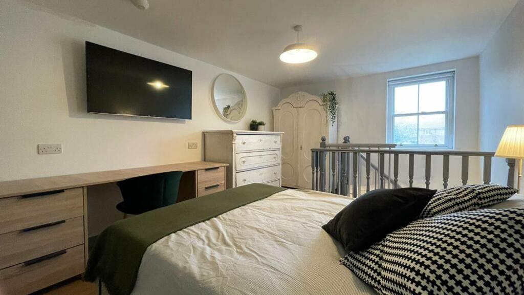 A stylish and well lit double bedroom featuring...