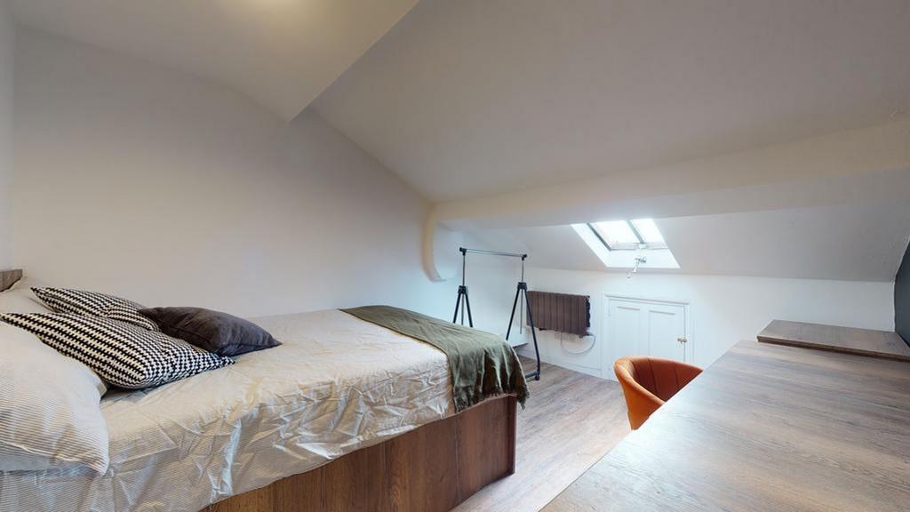 A bright and inviting double bedroom with a coz...