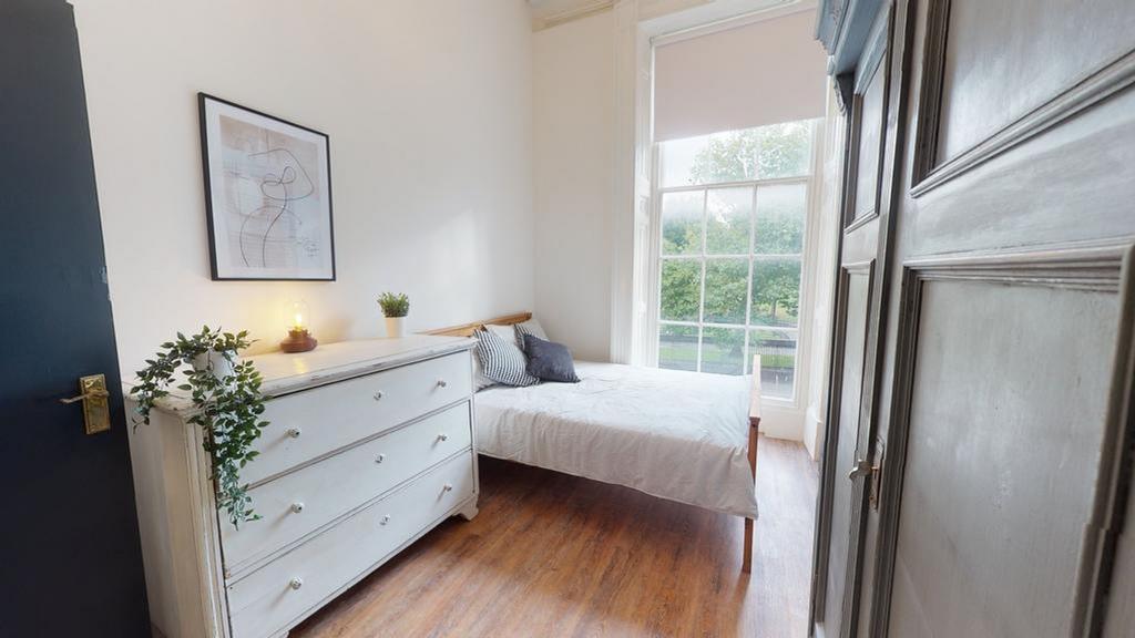 A bright and inviting double bedroom featuring ...