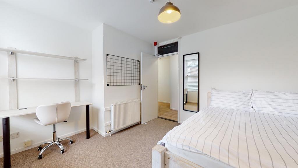 A bright and spacious double bedroom featuring ...