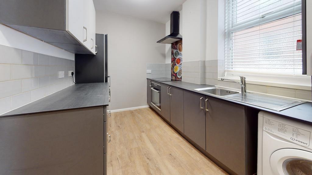 A spacious and modern kitchen with ample storag...