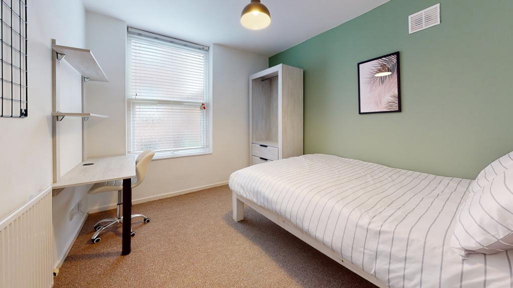 A bright and tidy double bedroom featuring a co...