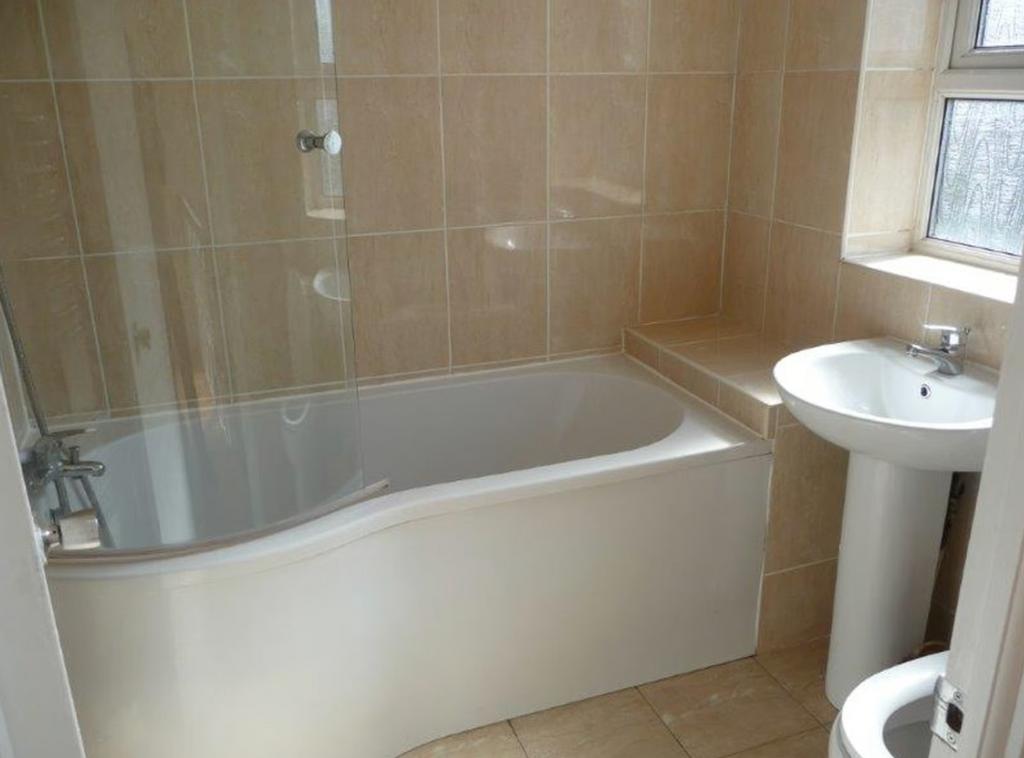 A spacious and clean bathroom featuring a moder...