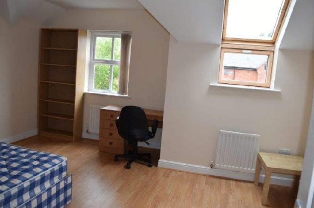 A bright and spacious double bedroom featuring ...