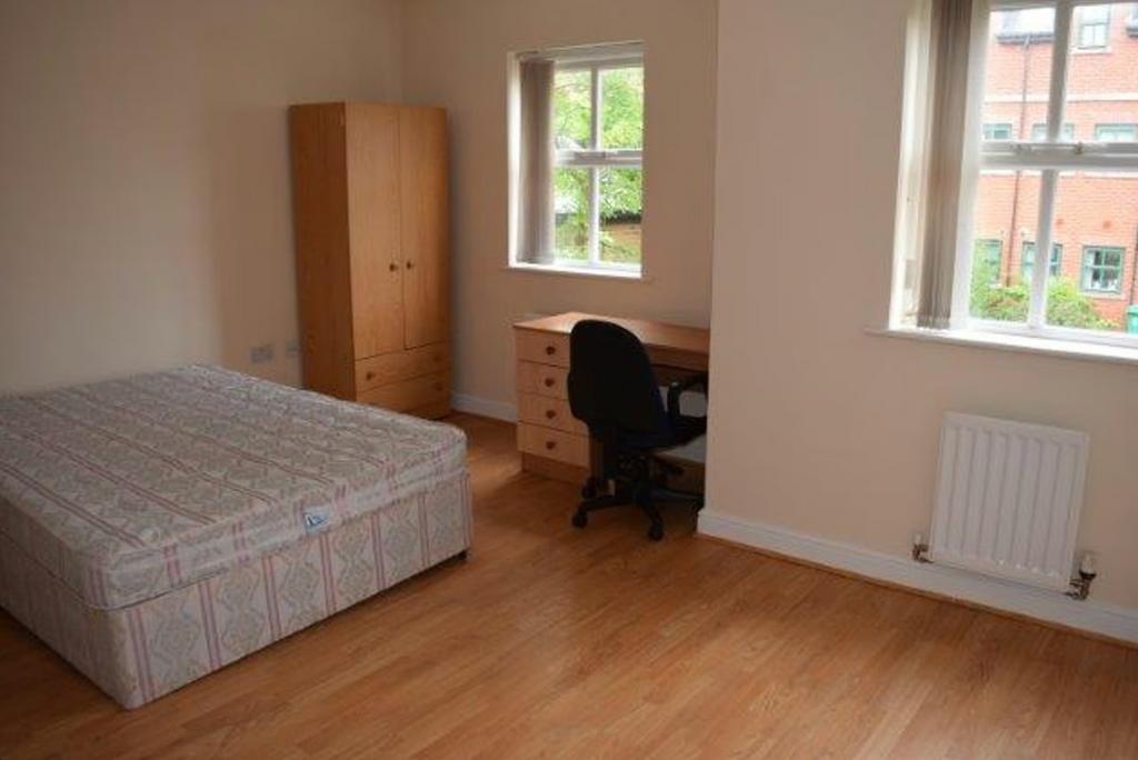 A bright and spacious double bedroom featuring ...
