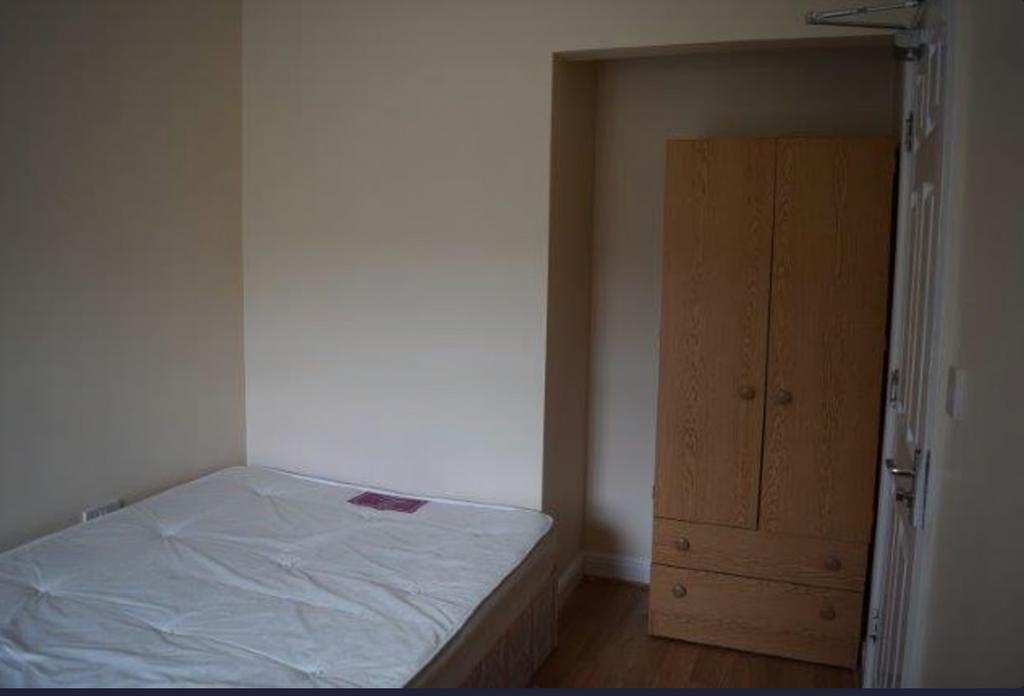 A tidy and functional double bedroom with ample...