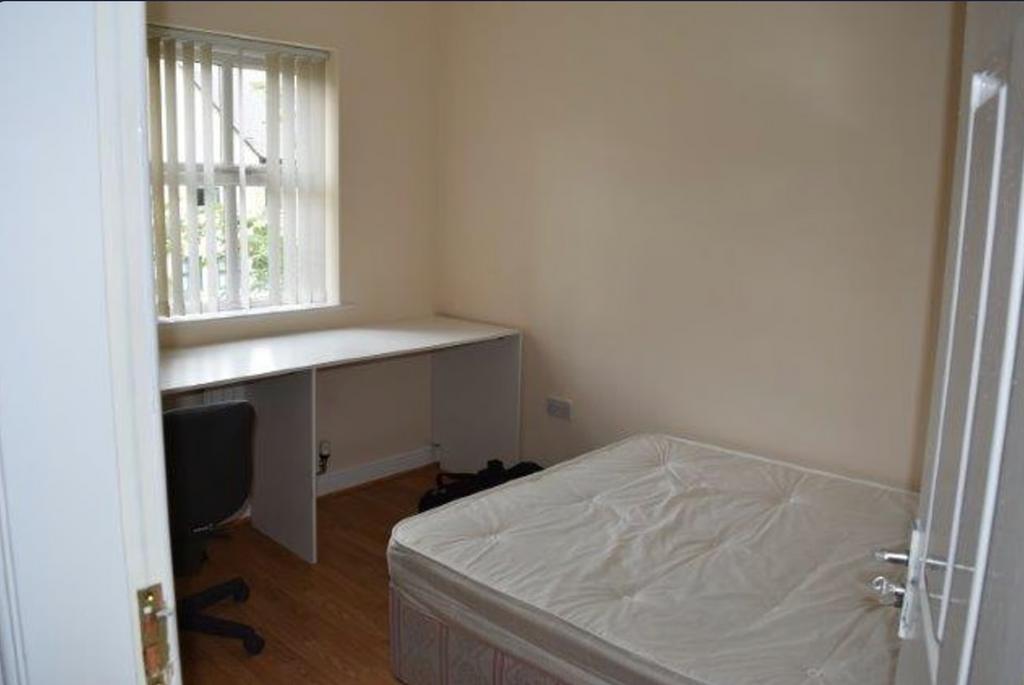 A spacious double bedroom with a large window, ...