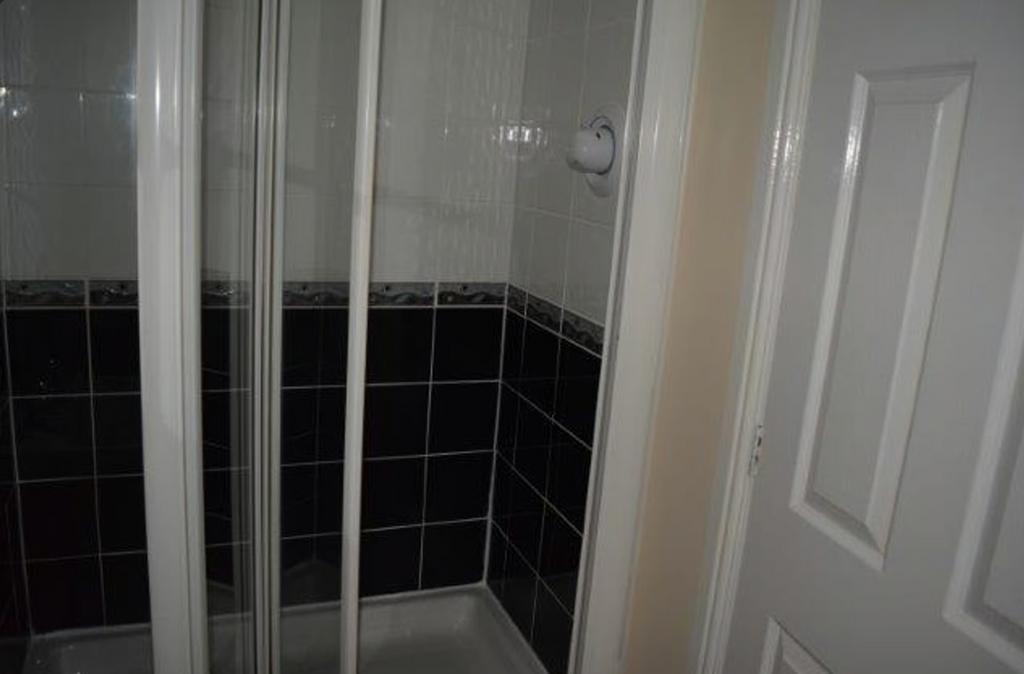 A tidy bathroom featuring a modern shower stall...