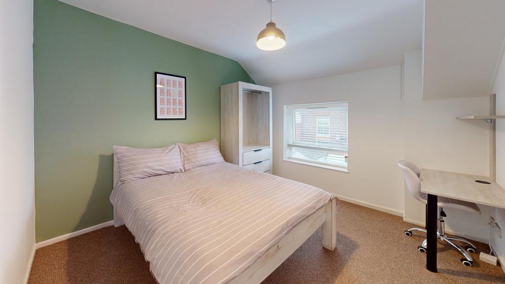 A bright and spacious double bedroom featuring ...