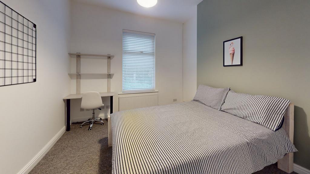 A spacious and inviting double bedroom, perfect...