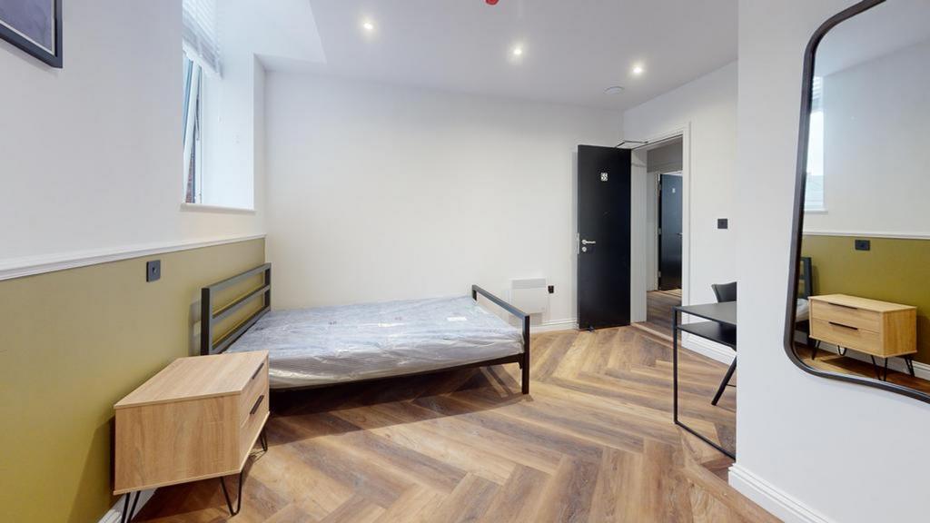 A spacious and stylish double bedroom with mode...