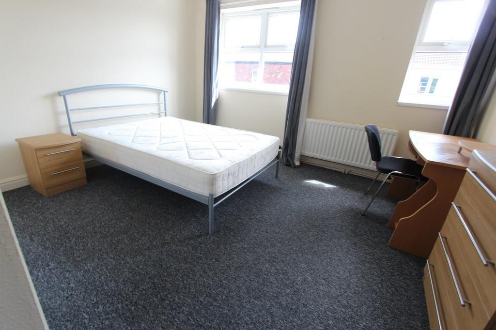 A spacious and well lit double bedroom with amp...