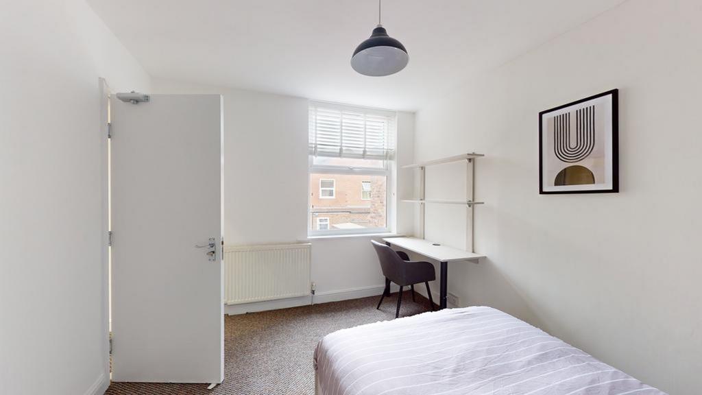 A bright and inviting double bedroom featuring ...