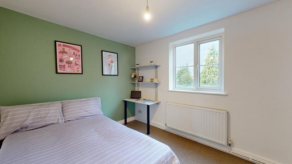 A bright and inviting double bedroom featuring ...