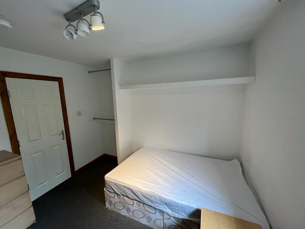 A spacious double bedroom with ample storage an...