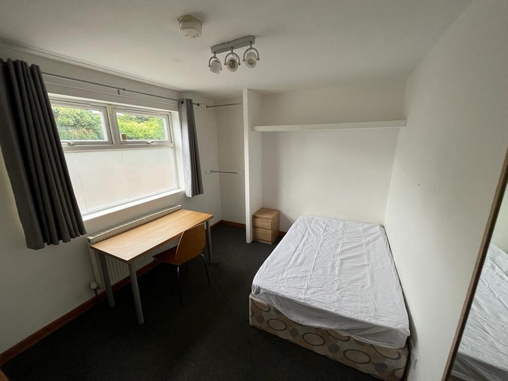 A bright and spacious double bedroom featuring ...