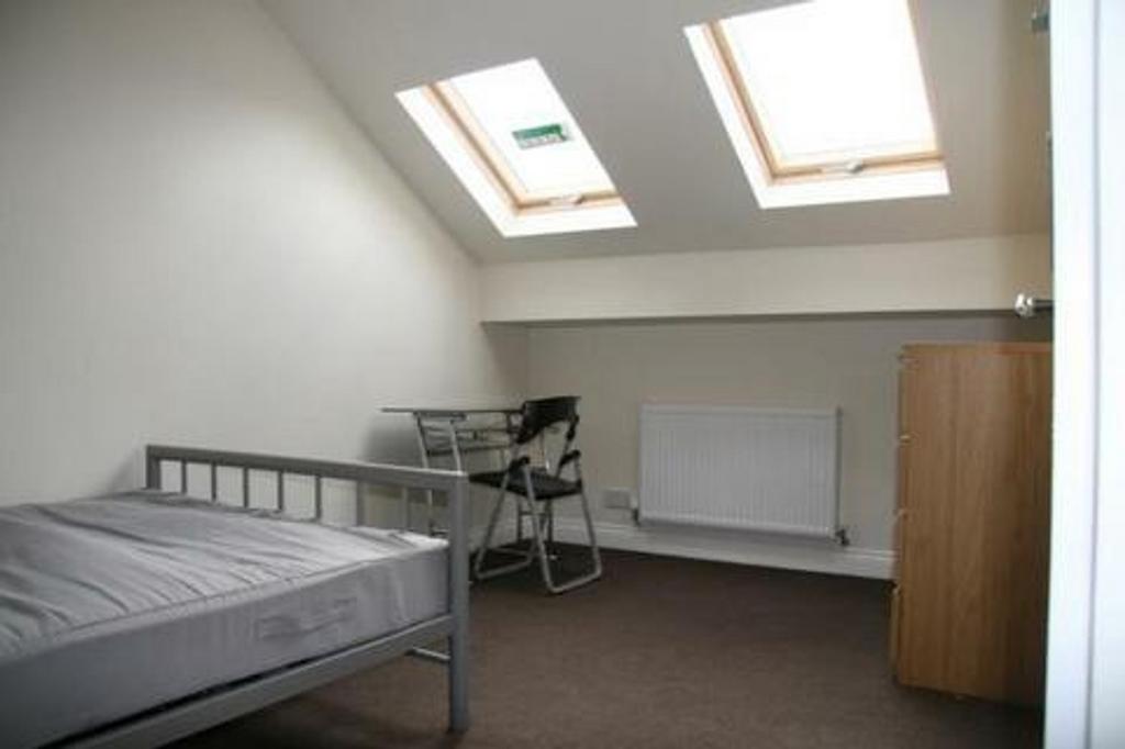 A bright and inviting double bedroom featuring ...