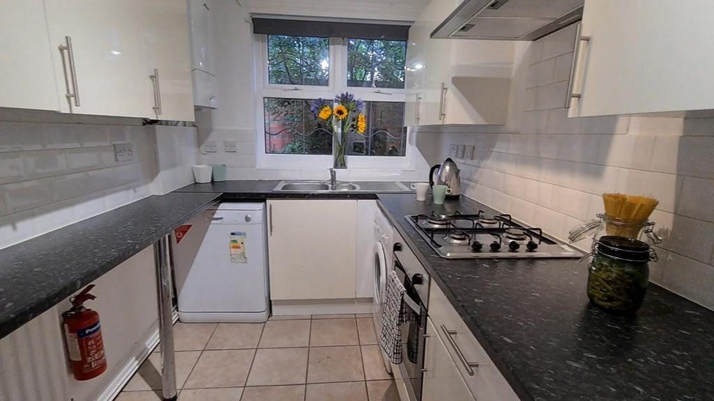 A bright and tidy kitchen featuring modern appl...