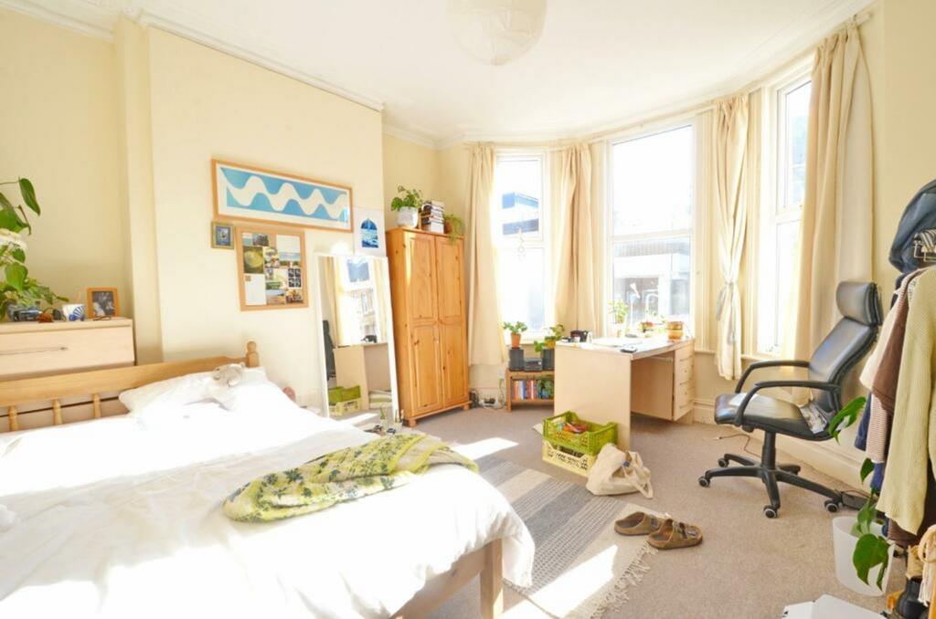 A bright and spacious double bedroom with ample...