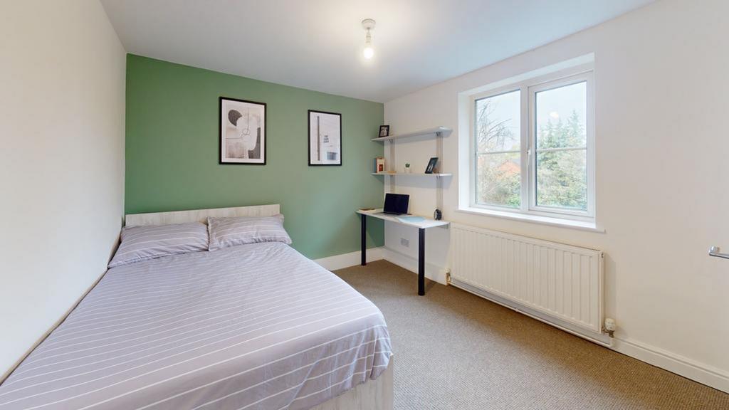 A bright and inviting double bedroom featuring ...