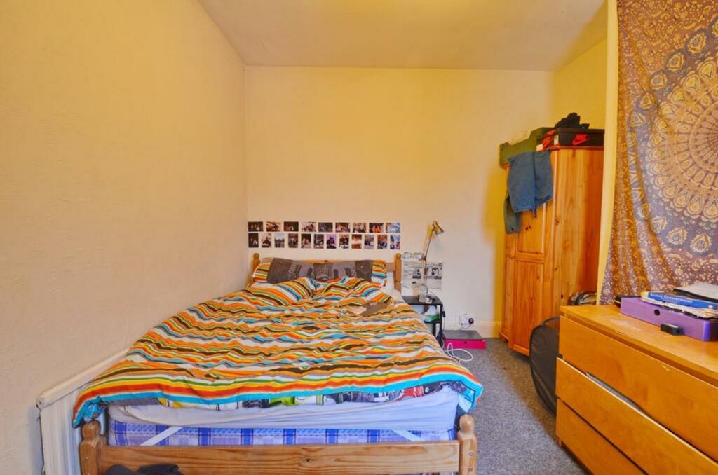 A cozy double bedroom featuring a warm color pa...