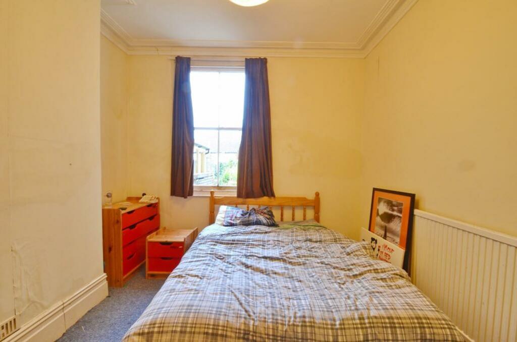 A cozy double bedroom with natural light and a ...