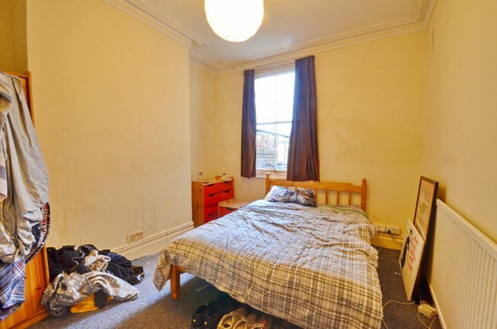 A cozy double bedroom with ample natural light ...