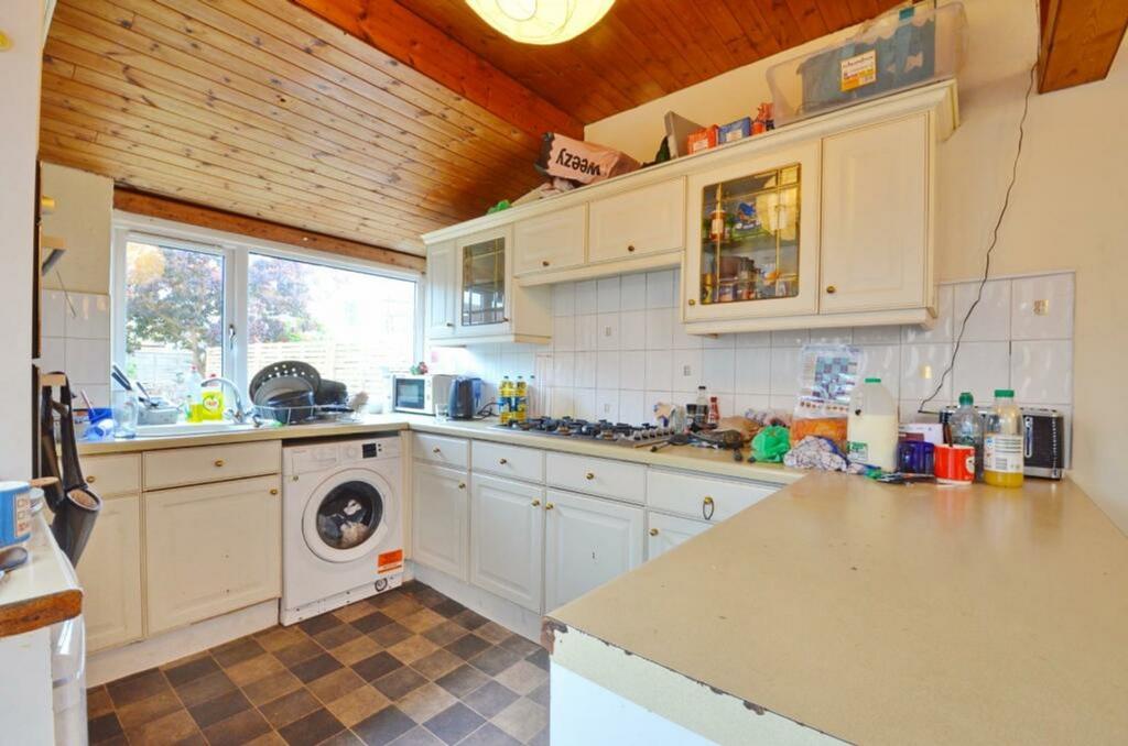 A bright and functional kitchen with ample stor...