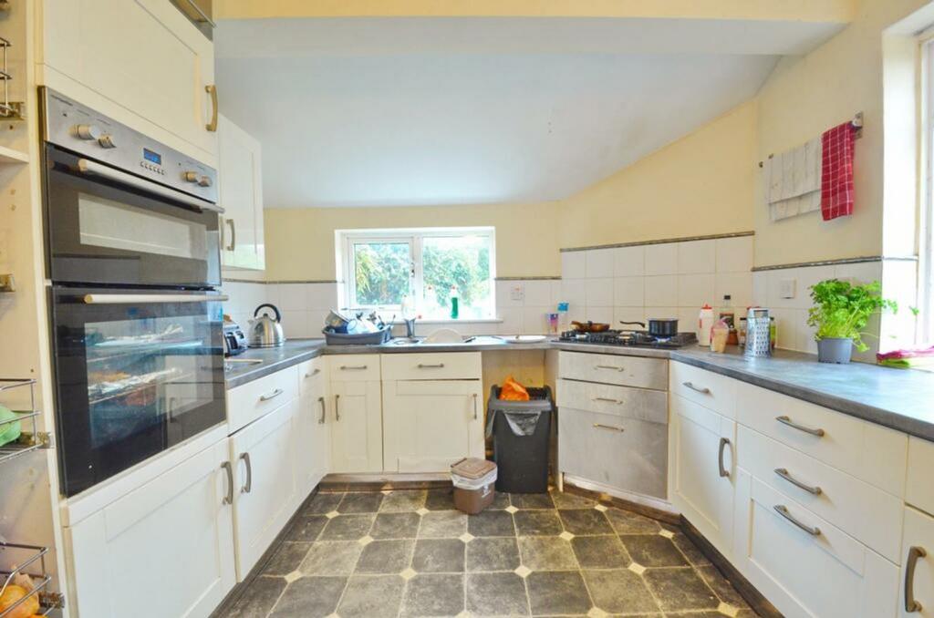 A bright and spacious kitchen featuring ample s...