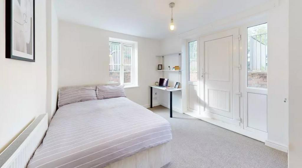 A bright and inviting double bedroom featuring ...