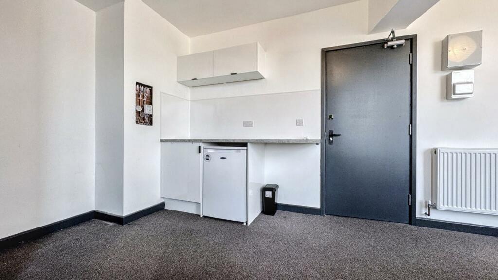 A tidy and functional kitchenette with modern a...