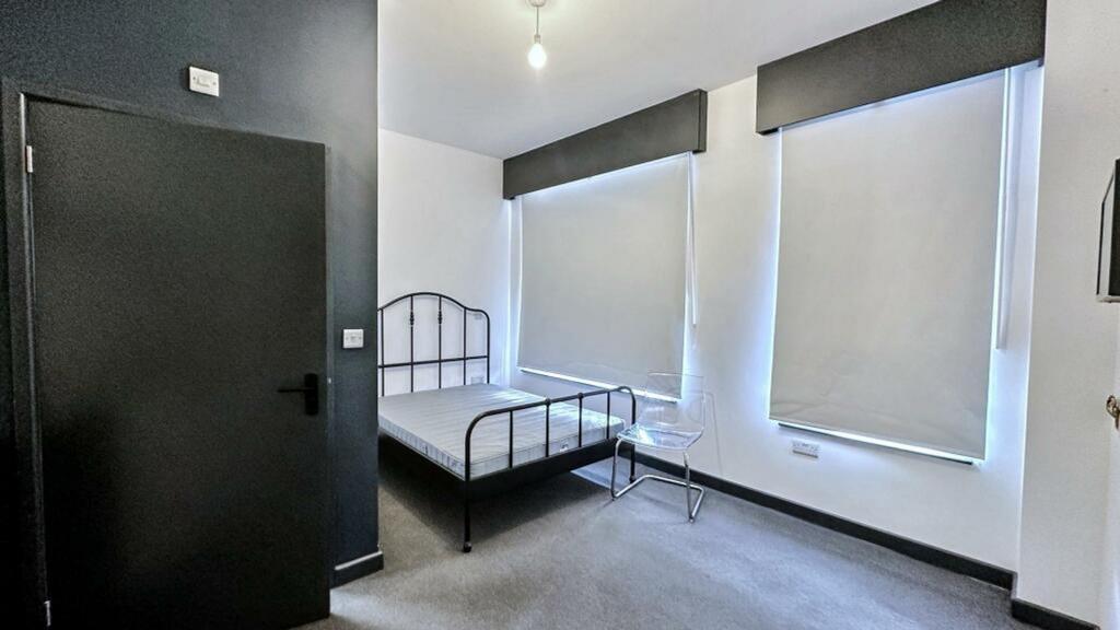 A spacious and well-lit double bedroom perfect ...