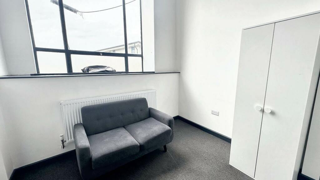 A bright and tidy living room with ample natura...