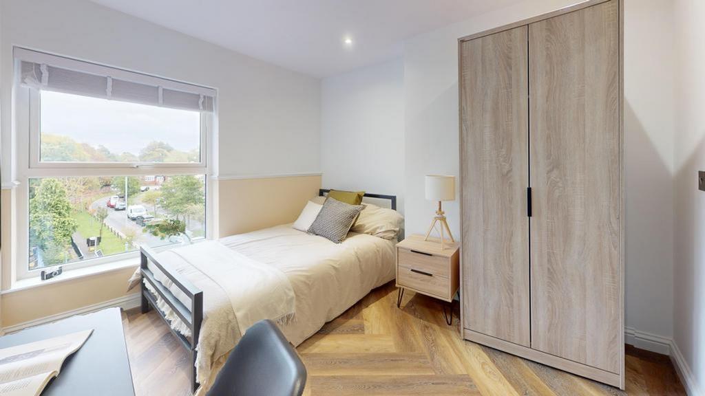 A bright and inviting double bedroom featuring ...