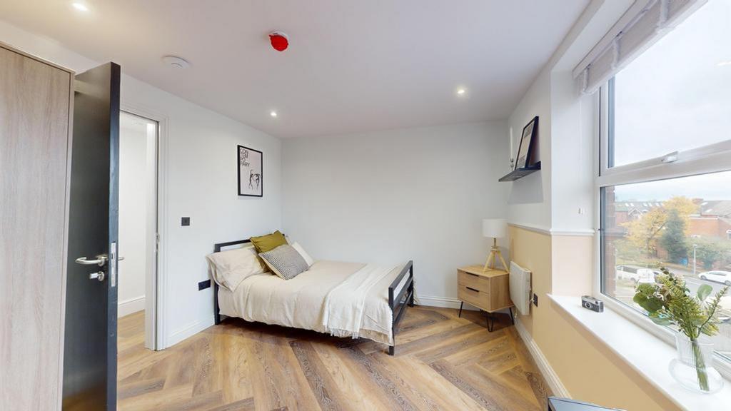 A bright and inviting double bedroom with moder...