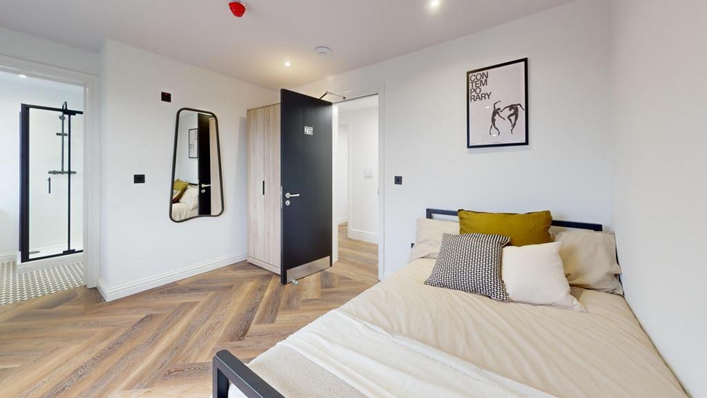 A stylish and well-lit double bedroom featuring...